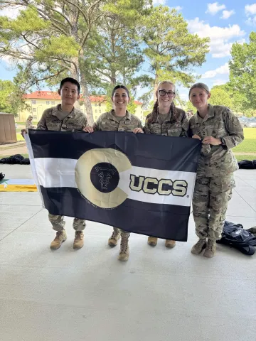 group of Air Force ROTC cadets holding the UCCS flag
